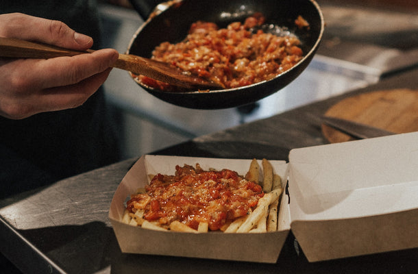 food being put into a takeout box